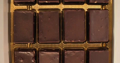 Chocolate bar display in a box on a white background for sweet treat lovers Stock Footage 331383774