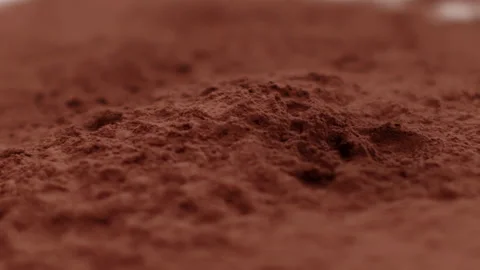 Chocolate bar falls into raw cocoa powder slow mo, confectionary shop ads Video stock 141207940