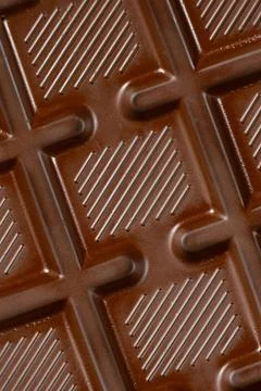 Chocolate bar with geometric line pattern, texture macro background Stock Photos