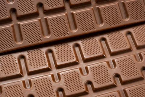 Chocolate bar with geometric line pattern, texture macro background Stock Photos
