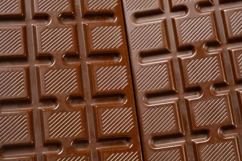 Chocolate bar with geometric line pattern, texture macro background Stock Photos