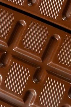 Chocolate bar with geometric line pattern, texture macro background Stock Photos