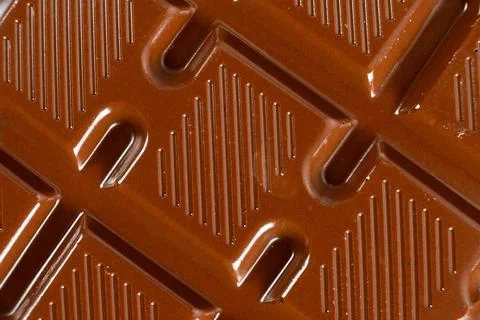Chocolate bar with geometric line pattern, texture macro background Stock Photos