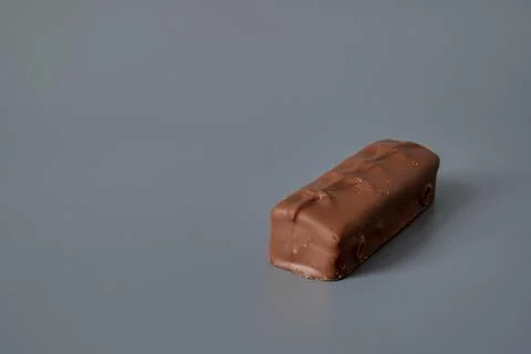 Chocolate bar on gray background Stock Photos