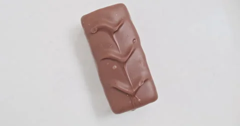Chocolate bar rotate on white background. Concept of obesity, unhealthy eating Stockbeeldmateriaal 280569783