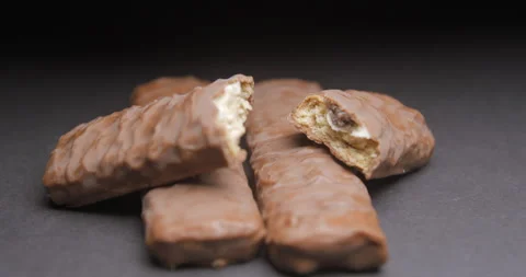 Chocolate bar rotating on black background Stock Footage 242302417