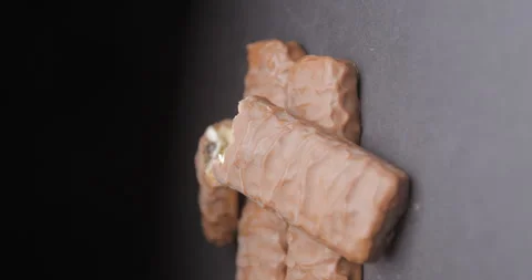 Chocolate bar rotating on black background, vertical Stock Footage 242302564