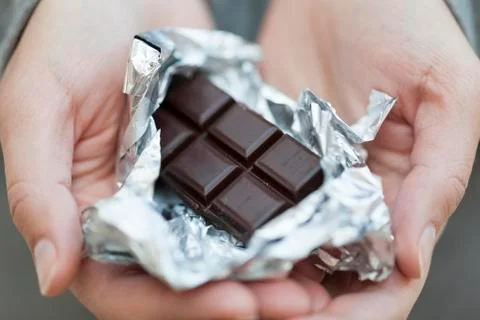 Chocolate bar in silver foil Stock Photos