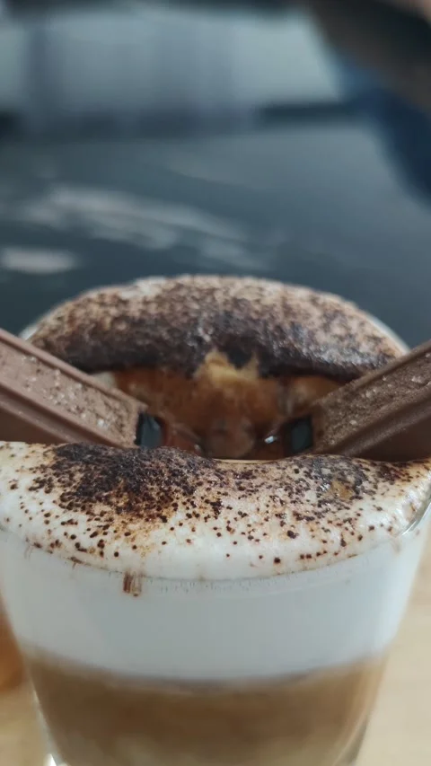Chocolate bar sinks into the coffee cup, close up shot, vertical video Stock Footage 245698922