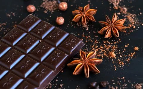 Chocolate bar with spice anise, chocolate flakes and powder Stock Photos
