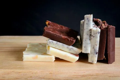 Chocolate bar stack on wooden background. Stock Photos