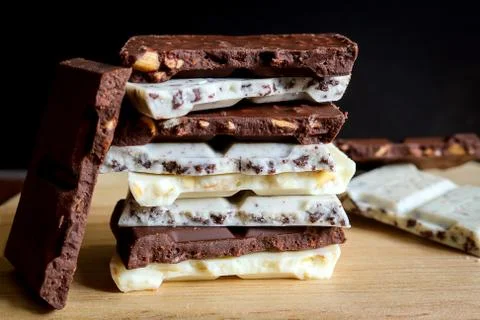 Chocolate bar stack on wooden background. 스톡 사진