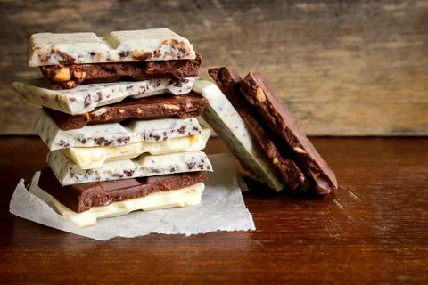 Chocolate bar stack on wooden background. 스톡 사진