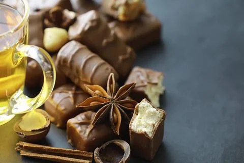 Chocolate bars on a black background in backlight. Chocolate with filling. .. Stock Photos