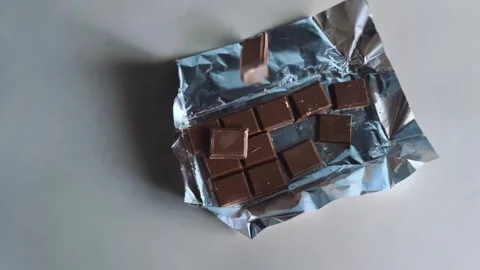 Chocolate bars fall on the table Stock Footage 265023254