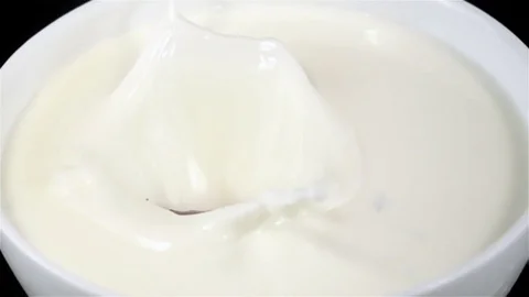 Chocolate Bars Falling on a Plate with Milk in Super Slow Motion Stock Footage 82303497