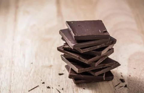 Chocolate Bars Stack on Wooden Table. Stock Photos