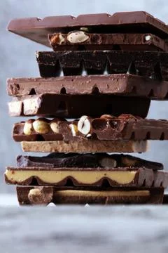 Chocolate bars on table with chocolate tower. Chocolate and nuts Stock Photos