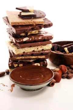 Chocolate bars on table with chocolate tower. Chocolate and nuts Stock Photos
