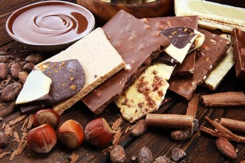 Chocolate bars on table with chocolate tower. Chocolate and nuts Stock Photos