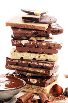 Chocolate bars on table with chocolate tower. Chocolate and nuts Stock Photos