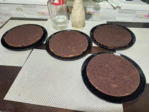 Chocolate biscuit cake layers on the kitchen table Stock Photos