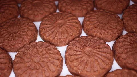 Chocolate biscuit closeup texture video on rolling rotating looping plate Stock Footage 104330343