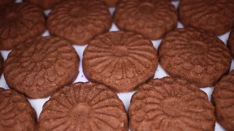 Chocolate biscuit closeup texture video on rolling rotating looping plate Stock Footage 104330585