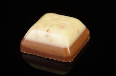 Chocolate bite isolated on black background Foto stock