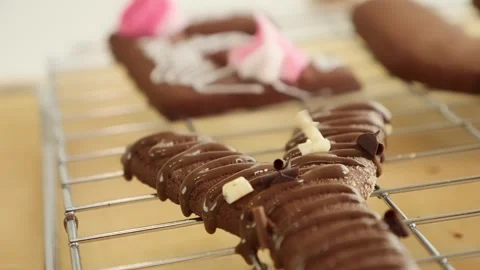 Chocolate bits falling on a chocolate biscuit in slow motion Stock Footage 253609696