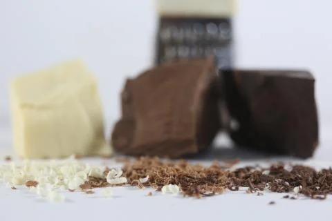 Chocolate blocks and grater Stock Photos