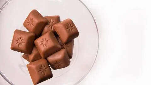 Chocolate blocks stack on wineglass Stock Photos