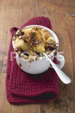Chocolate bread and butter pudding in cup with spoon Stock Photos