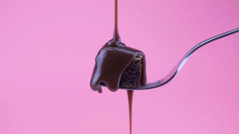 Chocolate Brownie slice on a fork with almonds, and pouring melted chocolat.. Stock Footage 233382201