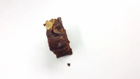 Chocolate brownie slice with sliced almonds rotating in slow motion Stock Footage 334719964