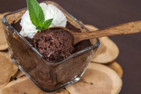 Chocolate brownie in a transparent rectangular baking dish, served with a min 스톡 사진