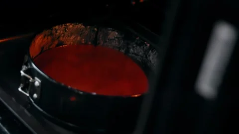 Chocolate cake baking inside a round springform tin, 4K Stock Footage 341120960