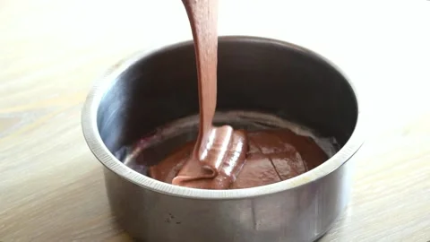 Chocolate cake batter pour into the mold slow motion Stock Footage 137028559