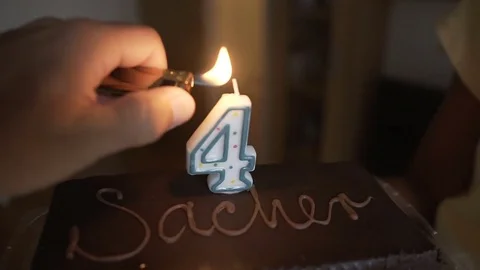Chocolate cake on the birthday a little boy. The birthday of children, we light Stock Footage