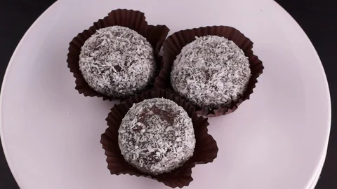 Chocolate cake in coconut flakes Stock Footage 123696698