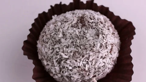 Chocolate cake in coconut flakes Stock Footage 123696740