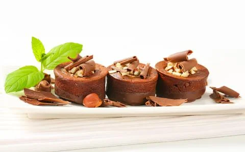 Chocolate cake cups with nuts and chocolate shavings Stock Photos