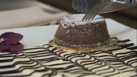 Chocolate cake cutting on dessert plate Stock Footage