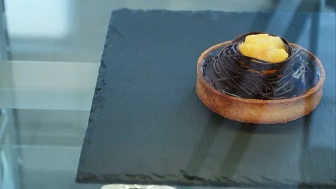 Chocolate cake decorated in shop window 스톡 동영상 77424315