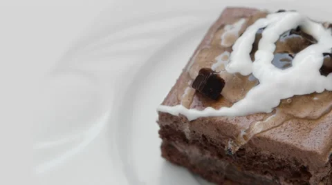 Chocolate cake with decoration, rotating on a white plate Stock Footage 54339312