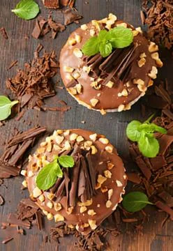 Chocolate cake with nuts and mint garnish Stock Photos