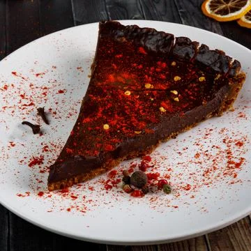 Chocolate cake with pepper on a plate. Stock Photos