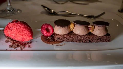 Chocolate cake with raspberry, hazelnut and ice cream. Delicious dessert. Stock Photos