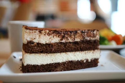 Chocolate cake slice on a white plate at a cafe Stock Photos