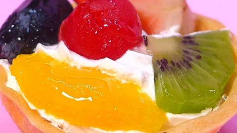 Chocolate cake square Spin on orange palette Stock Footage 74202242